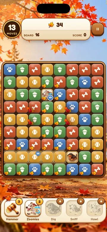 Paw Pop autumn board: a grid of acorn, paw, bone and ball tiles with booster buttons below